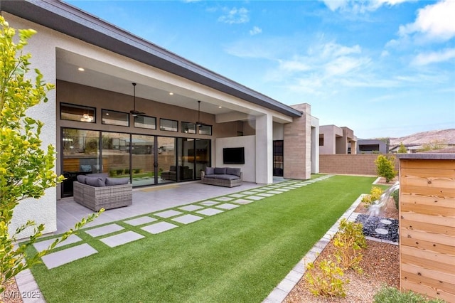 view of yard with a patio area, an outdoor living space, ceiling fan, and fence