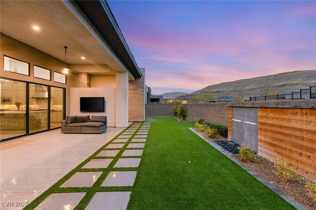 view of yard featuring a patio, an outdoor hangout area, and a fenced backyard