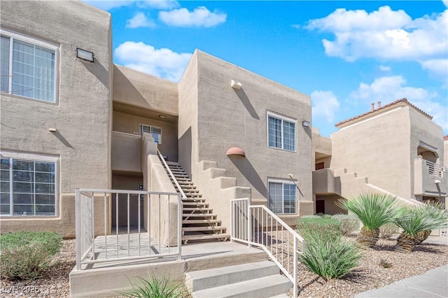 entrance to property featuring stucco siding