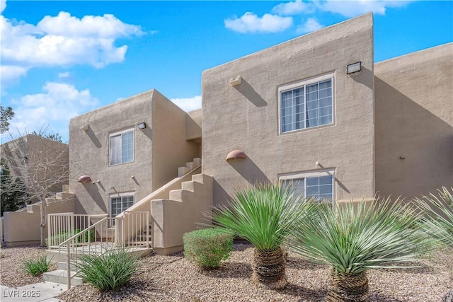 view of front of property featuring fence and stucco siding