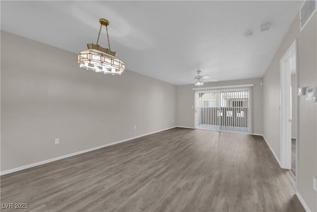 unfurnished living room featuring visible vents, a ceiling fan, baseboards, and wood finished floors