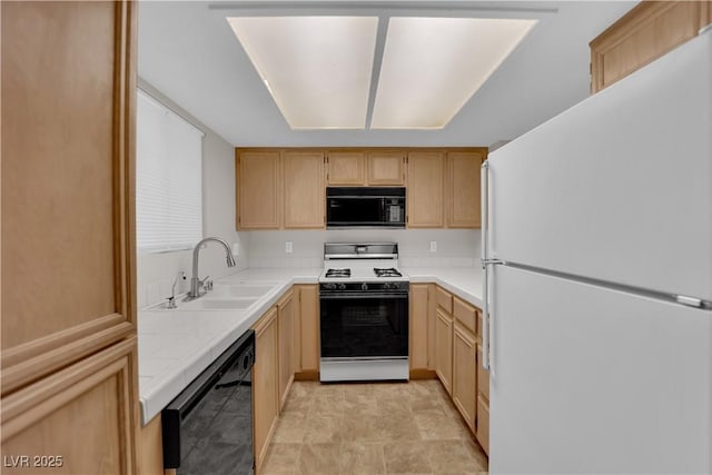 kitchen featuring black appliances, tile counters, light brown cabinets, and a sink