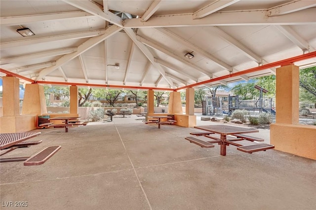 view of community featuring a patio area, a gazebo, a trampoline, and fence