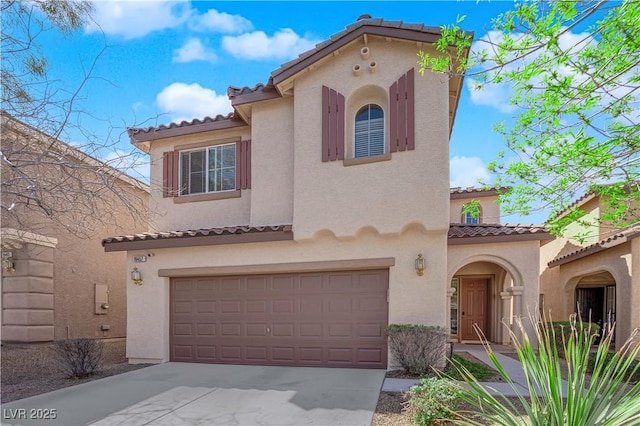 mediterranean / spanish-style house with stucco siding, a garage, driveway, and a tiled roof