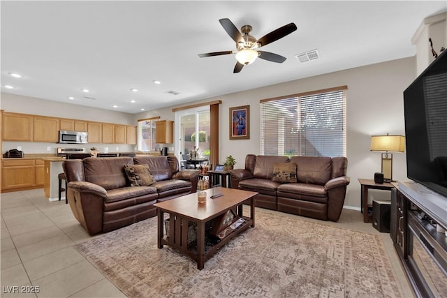 living room with light tile patterned floors, visible vents, and recessed lighting