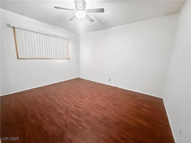 empty room featuring wood finished floors, a ceiling fan, and baseboards