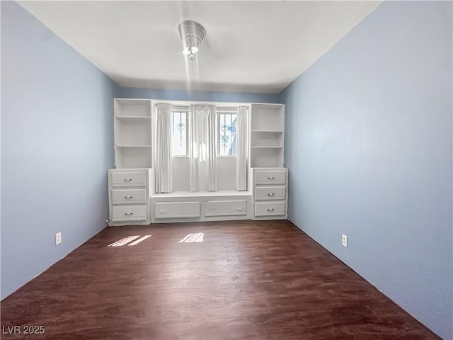 unfurnished bedroom with dark wood-type flooring