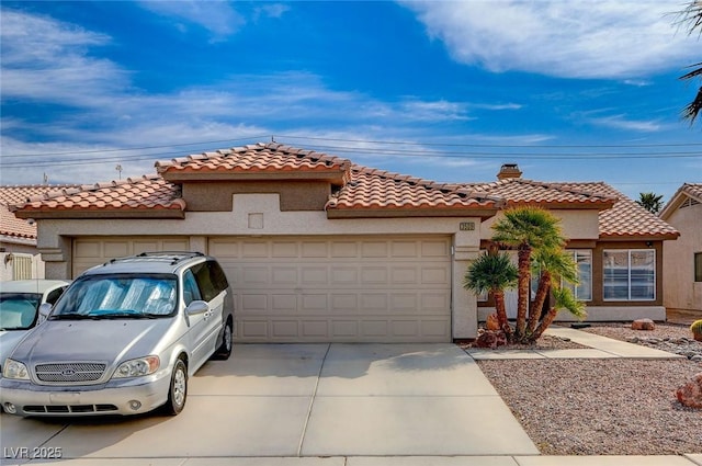 mediterranean / spanish-style home featuring a tile roof, stucco siding, an attached garage, and concrete driveway