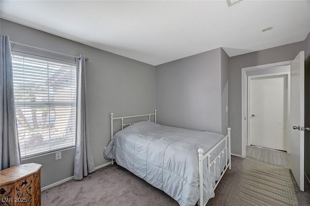 bedroom with multiple windows and baseboards