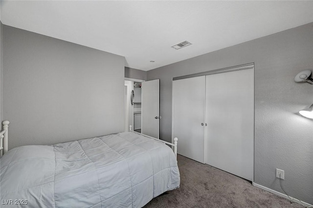 bedroom with a closet, visible vents, and carpet floors