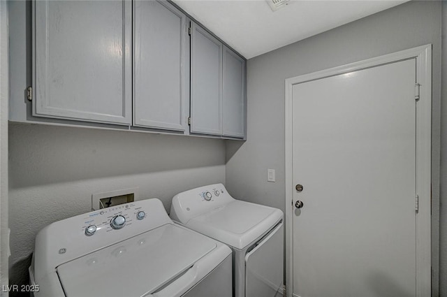 laundry area featuring washer and dryer and cabinet space