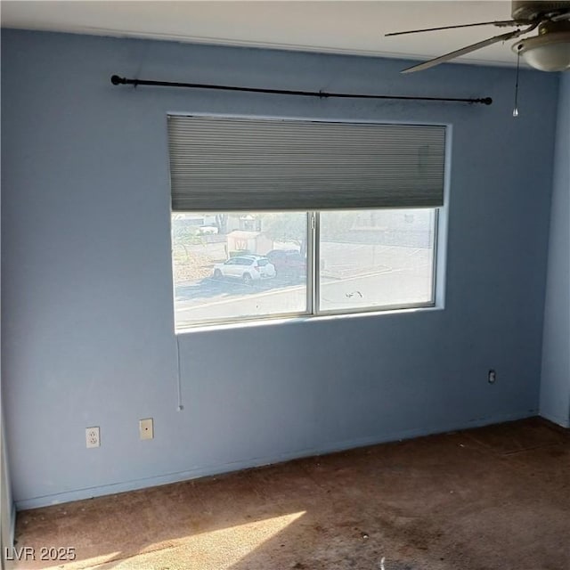 unfurnished room with a ceiling fan and carpet floors