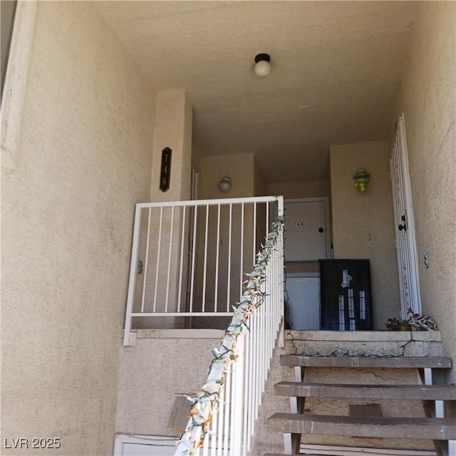 doorway to property featuring stucco siding