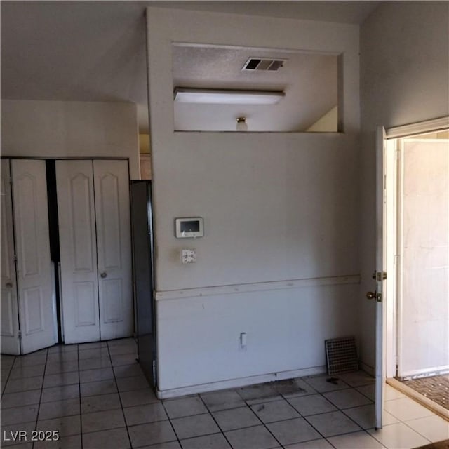 interior space with light tile patterned floors and visible vents