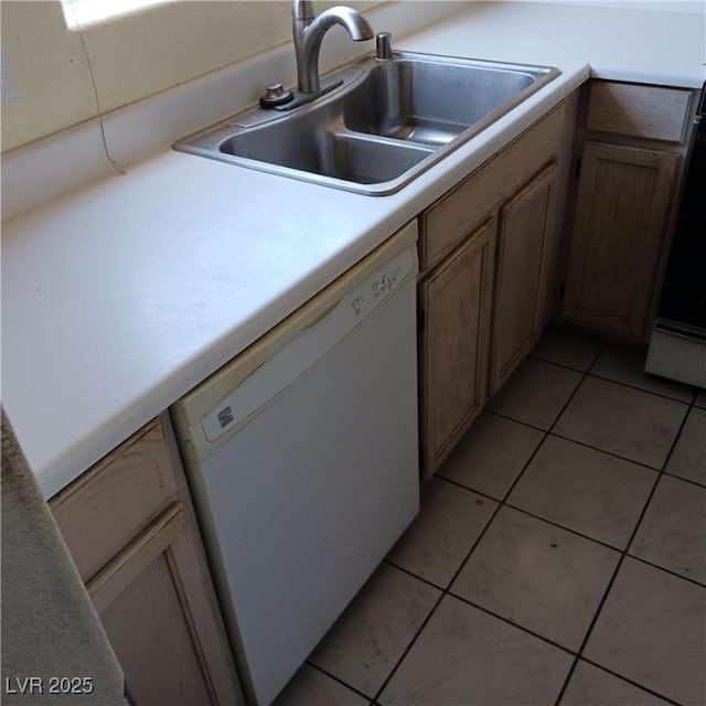 kitchen with a sink, light countertops, white dishwasher, and light tile patterned floors