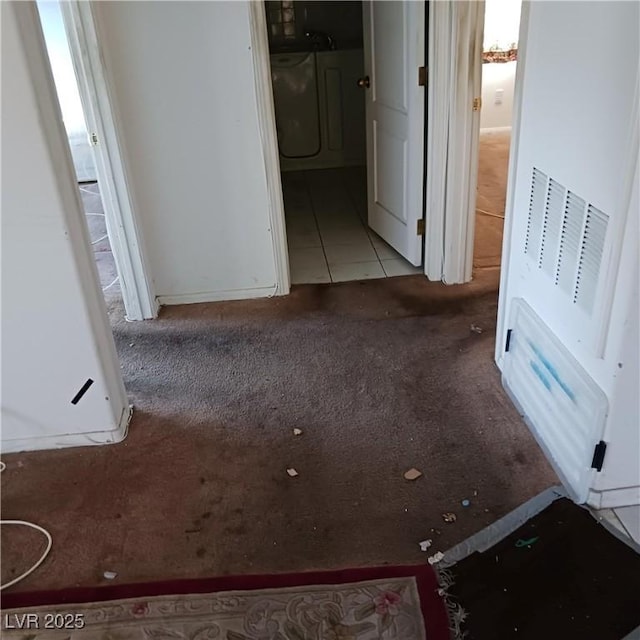 corridor with tile patterned flooring and carpet floors