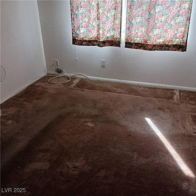 unfurnished room with carpet flooring and a textured wall