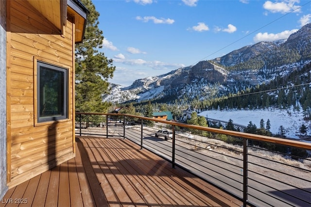 snow covered deck featuring a mountain view