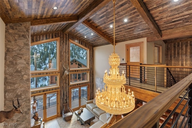 interior space featuring wooden ceiling, lofted ceiling with beams, and a notable chandelier