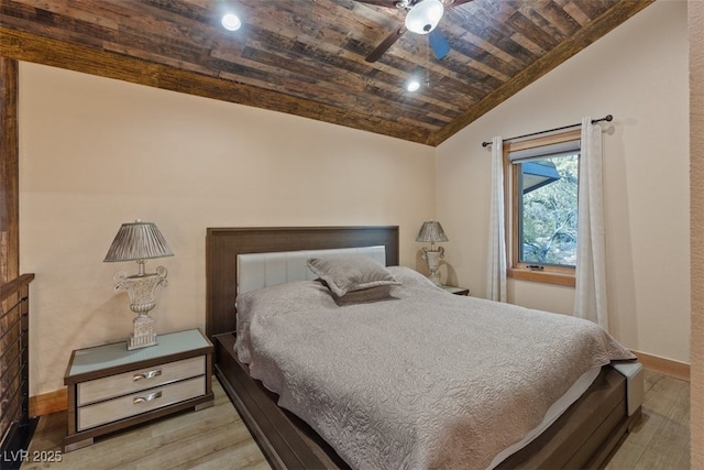 bedroom featuring lofted ceiling, a ceiling fan, wood finished floors, wooden ceiling, and baseboards