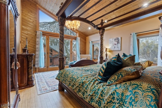 bedroom featuring a notable chandelier, high vaulted ceiling, wood finished floors, wood ceiling, and access to exterior