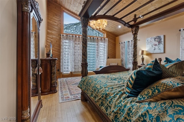 bedroom featuring lofted ceiling, hardwood / wood-style floors, recessed lighting, wooden ceiling, and an inviting chandelier