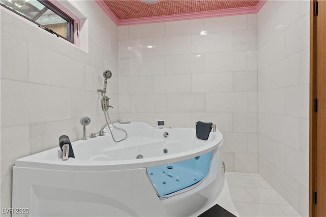 full bath featuring a tub with jets, tile walls, and ornamental molding