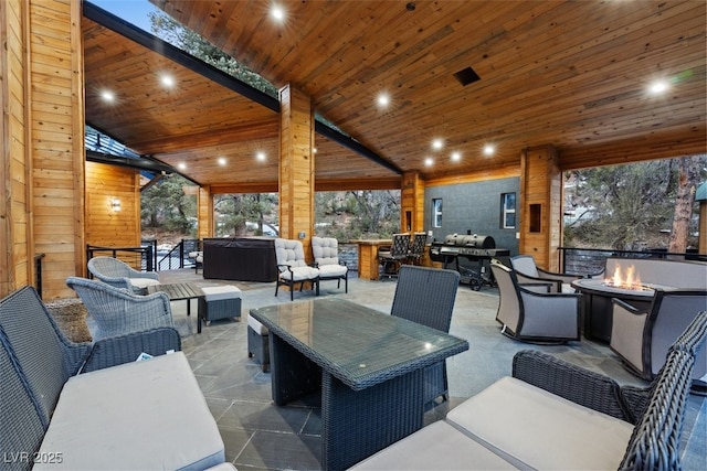 view of patio / terrace with an outdoor living space with a fire pit