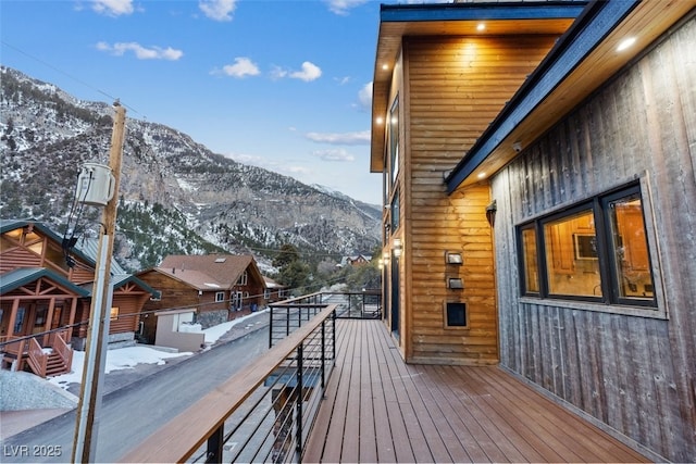 snow covered deck with a mountain view