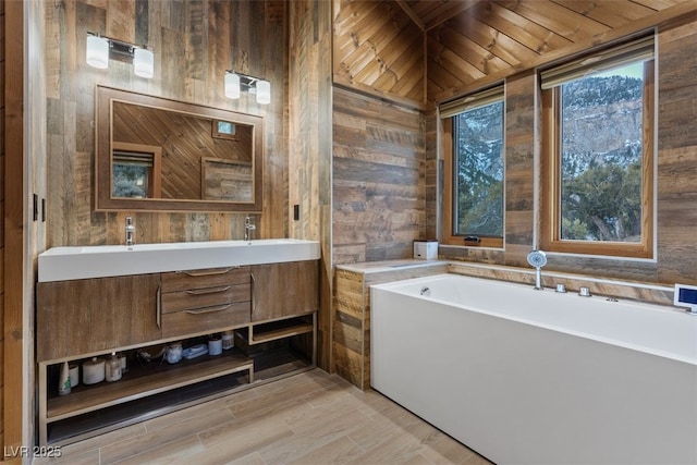 full bath featuring a tub, wooden walls, and double vanity