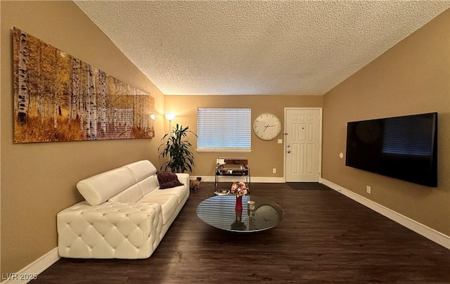 living room featuring baseboards, lofted ceiling, a textured ceiling, and wood finished floors