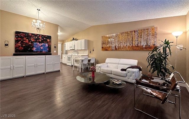 living area featuring lofted ceiling, a textured ceiling, an inviting chandelier, and dark wood-style flooring