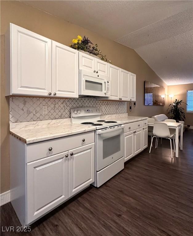 kitchen with white cabinetry, white appliances, dark wood-type flooring, and vaulted ceiling