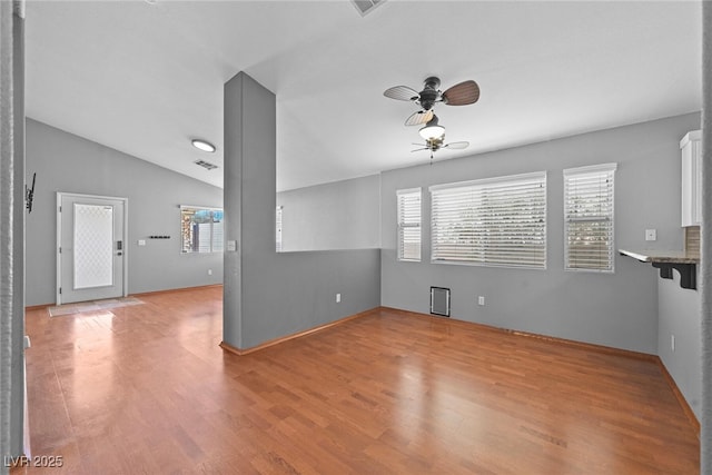 unfurnished living room featuring light wood-type flooring, a wealth of natural light, and ceiling fan