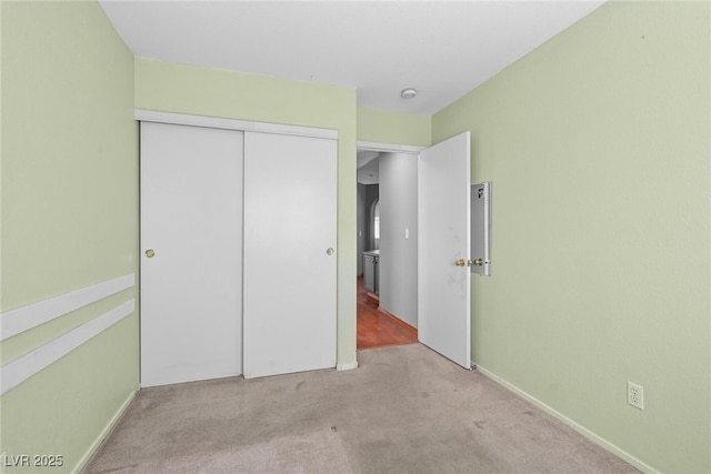 unfurnished bedroom with a closet and carpet flooring