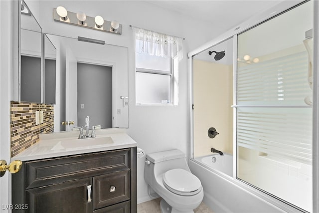 full bath featuring decorative backsplash, toilet, vanity, and bath / shower combo with glass door