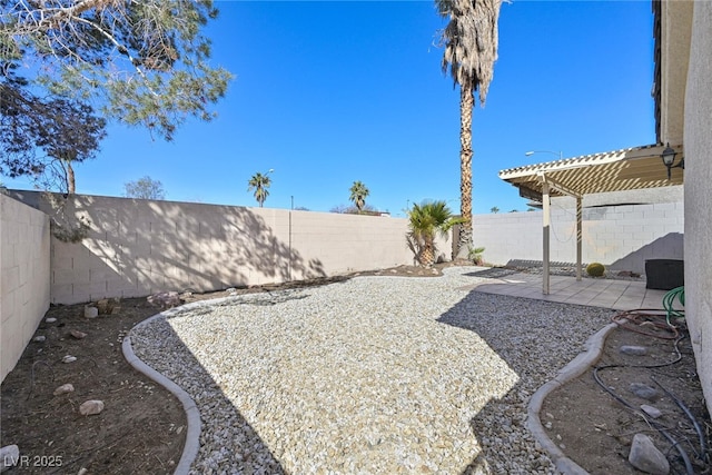 view of yard featuring a patio, a fenced backyard, and a pergola