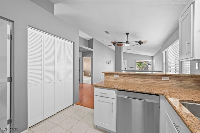 kitchen featuring visible vents, dishwasher, lofted ceiling, light tile patterned flooring, and a ceiling fan