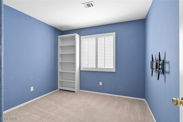 carpeted empty room featuring visible vents and baseboards