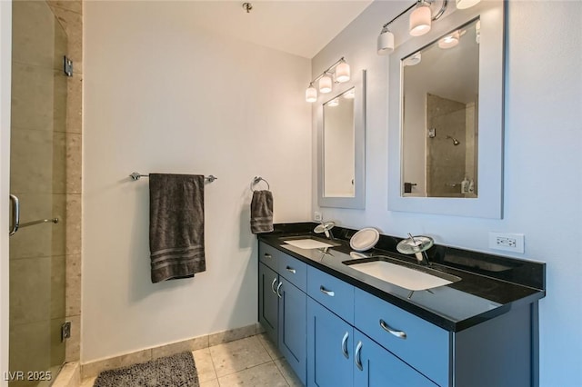 full bathroom with a sink, baseboards, a stall shower, and tile patterned flooring