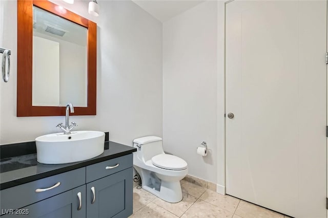 bathroom featuring tile patterned floors, visible vents, toilet, baseboards, and vanity