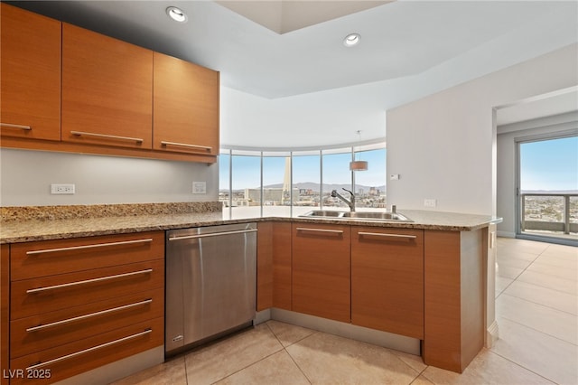 kitchen with a sink, light stone countertops, dishwasher, and recessed lighting