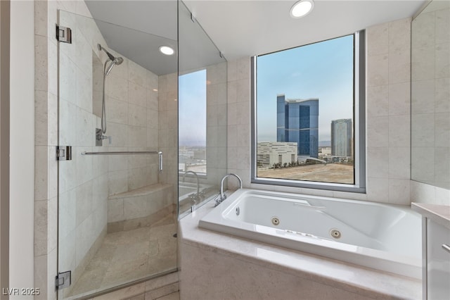 full bathroom featuring tile walls, a tub with jets, and a shower stall