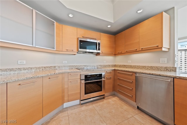 kitchen featuring light brown cabinets, light stone counters, light tile patterned floors, recessed lighting, and stainless steel appliances