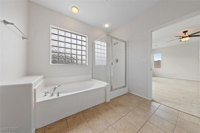 bathroom with tile patterned flooring, a bath, a stall shower, and ceiling fan