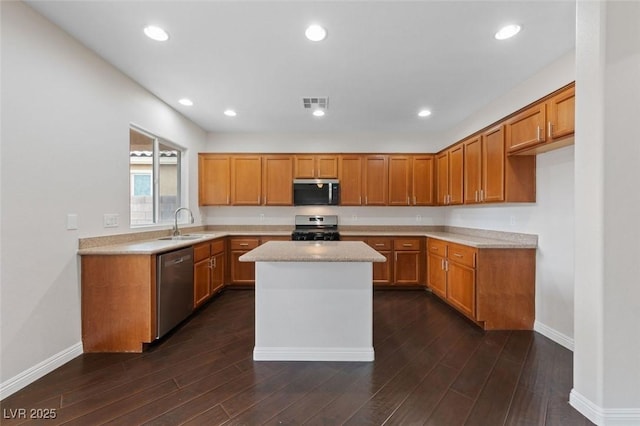 kitchen with stainless steel appliances, brown cabinetry, and light countertops