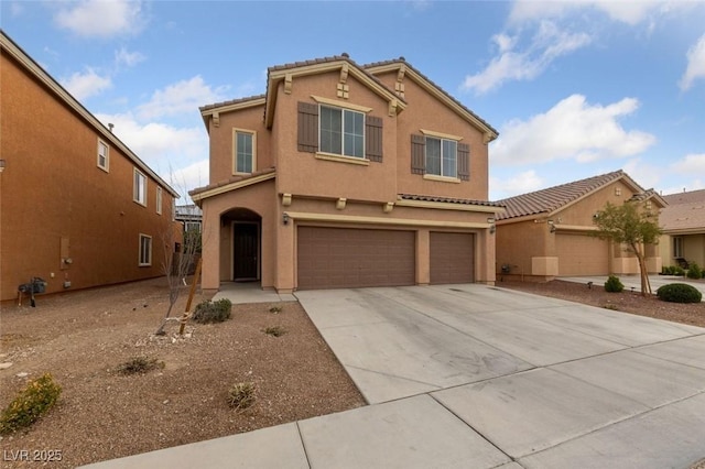 view of front of home featuring stucco siding, driveway, a tile roof, and a garage