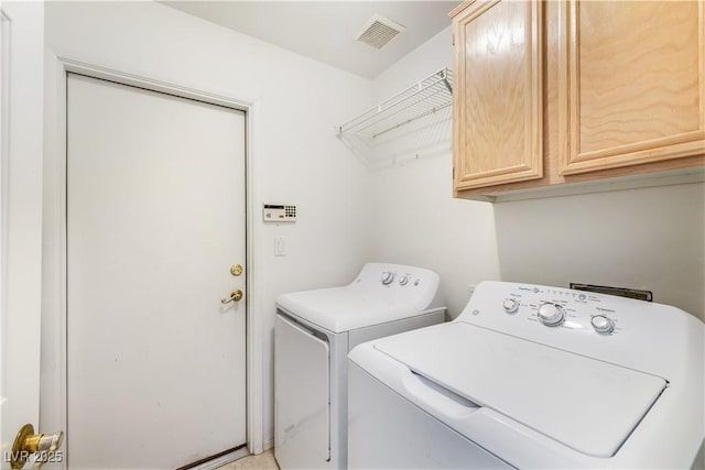 laundry area featuring visible vents, cabinet space, and independent washer and dryer