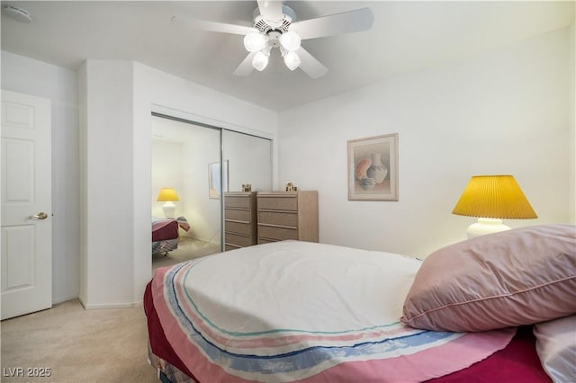 bedroom with a closet, carpet flooring, baseboards, and ceiling fan