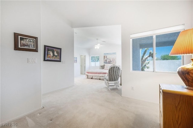 hall with vaulted ceiling, carpet flooring, and baseboards